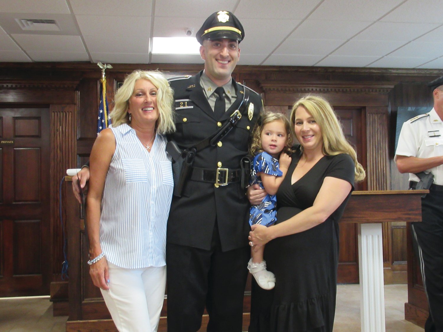 MEMORABLE MOMENT: Andrew Broccoli, a 9-year veteran of the Johnston Police Department, is joined by his wonderful wife Harley, their 2-year-old daughter Ryleigh and his mother Donna Broccoli after being promoted to the rank of sergeant.